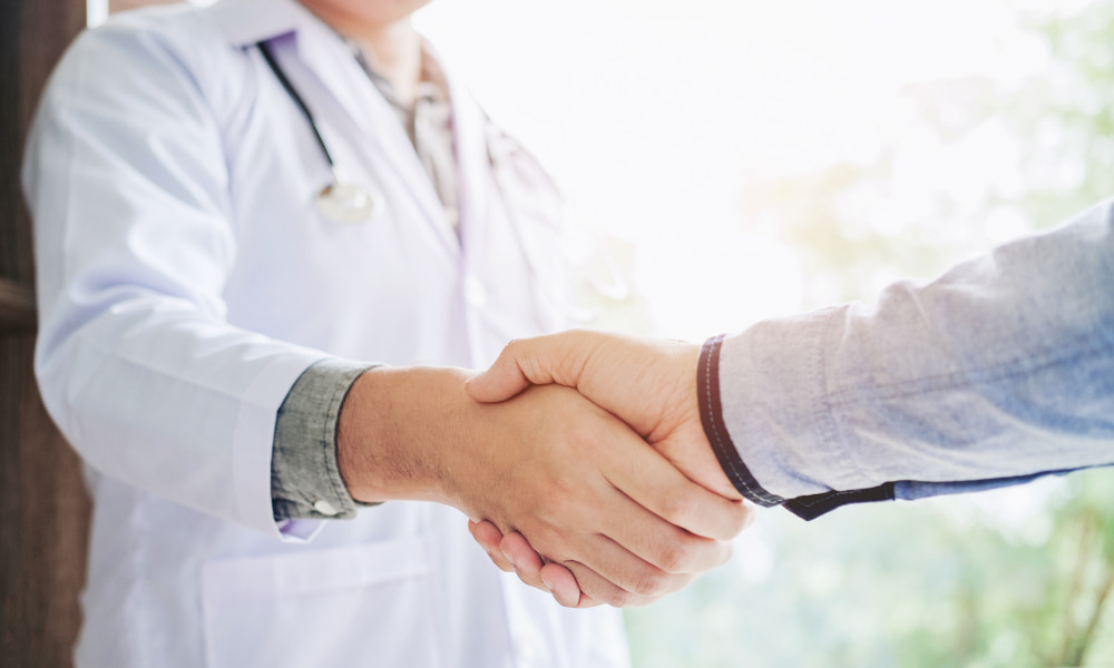 doctor shaking hand after signing medical office lease agreement